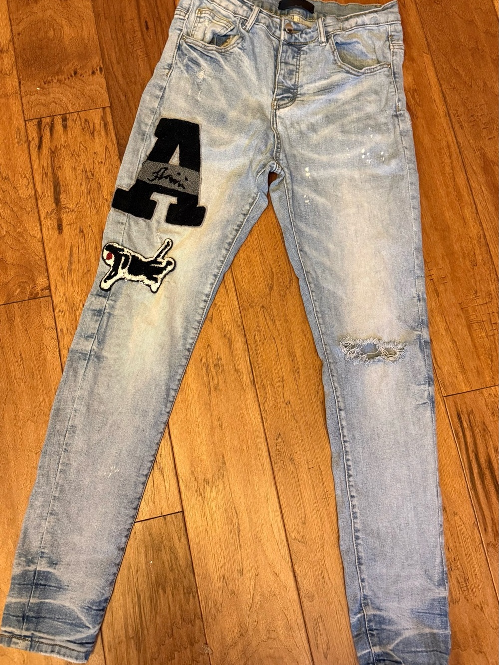 AMIRI Light Blue Distressed Skinny Jeans with Varsity Patch